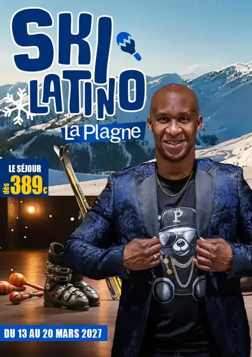 Professeur crâne rasé en veste bleue brodée, souriant