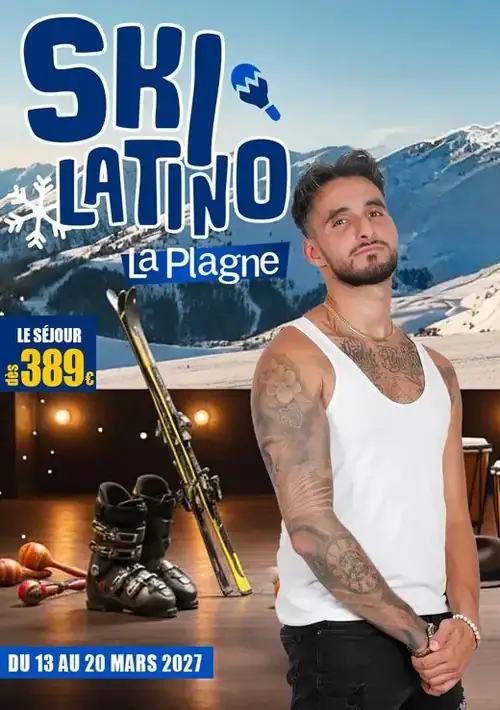 Professeur barbu en débardeur blanc, bras tatoués